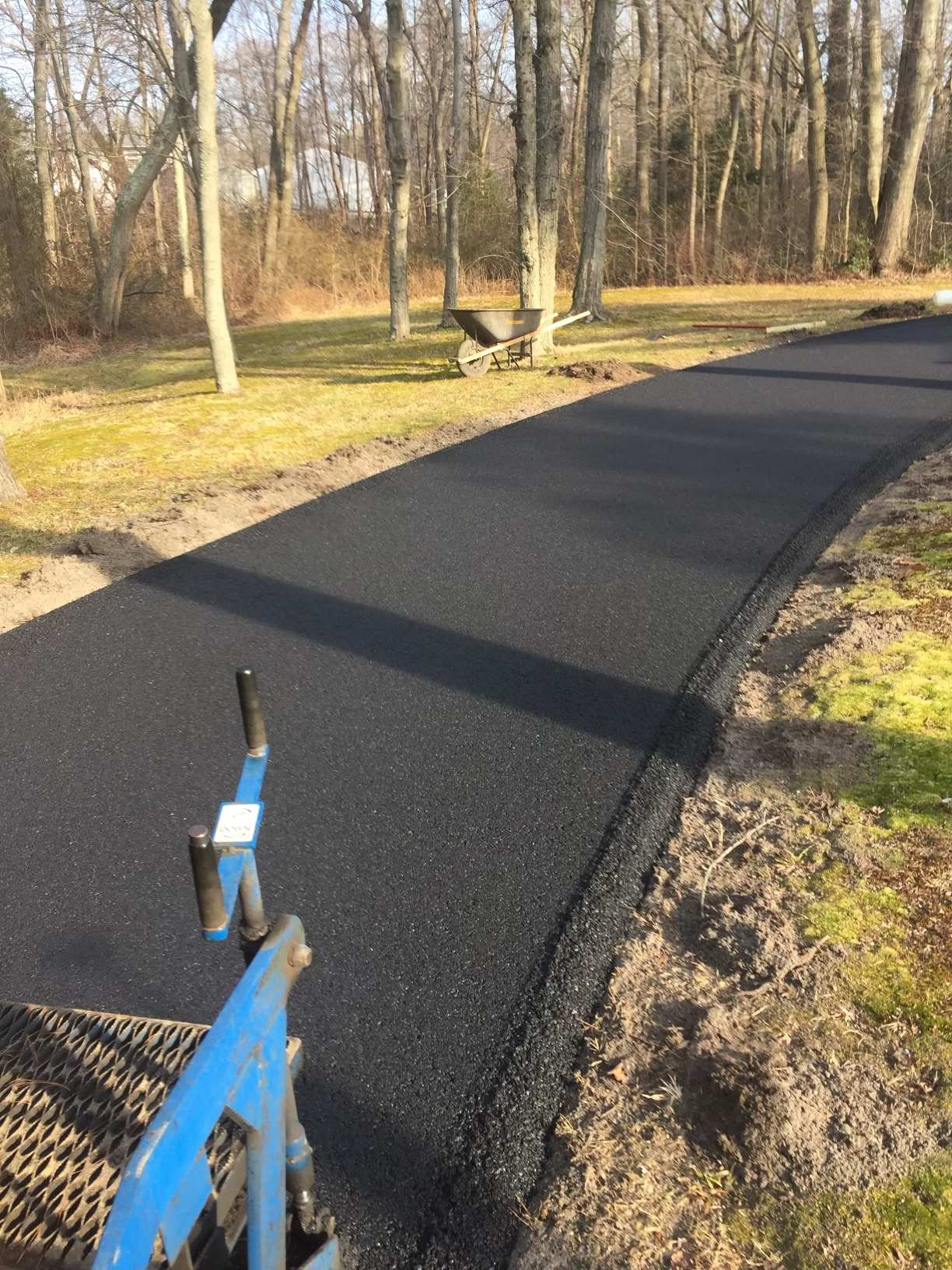 Fresh asphalt installation in progress - Harrison Paving crew at work
